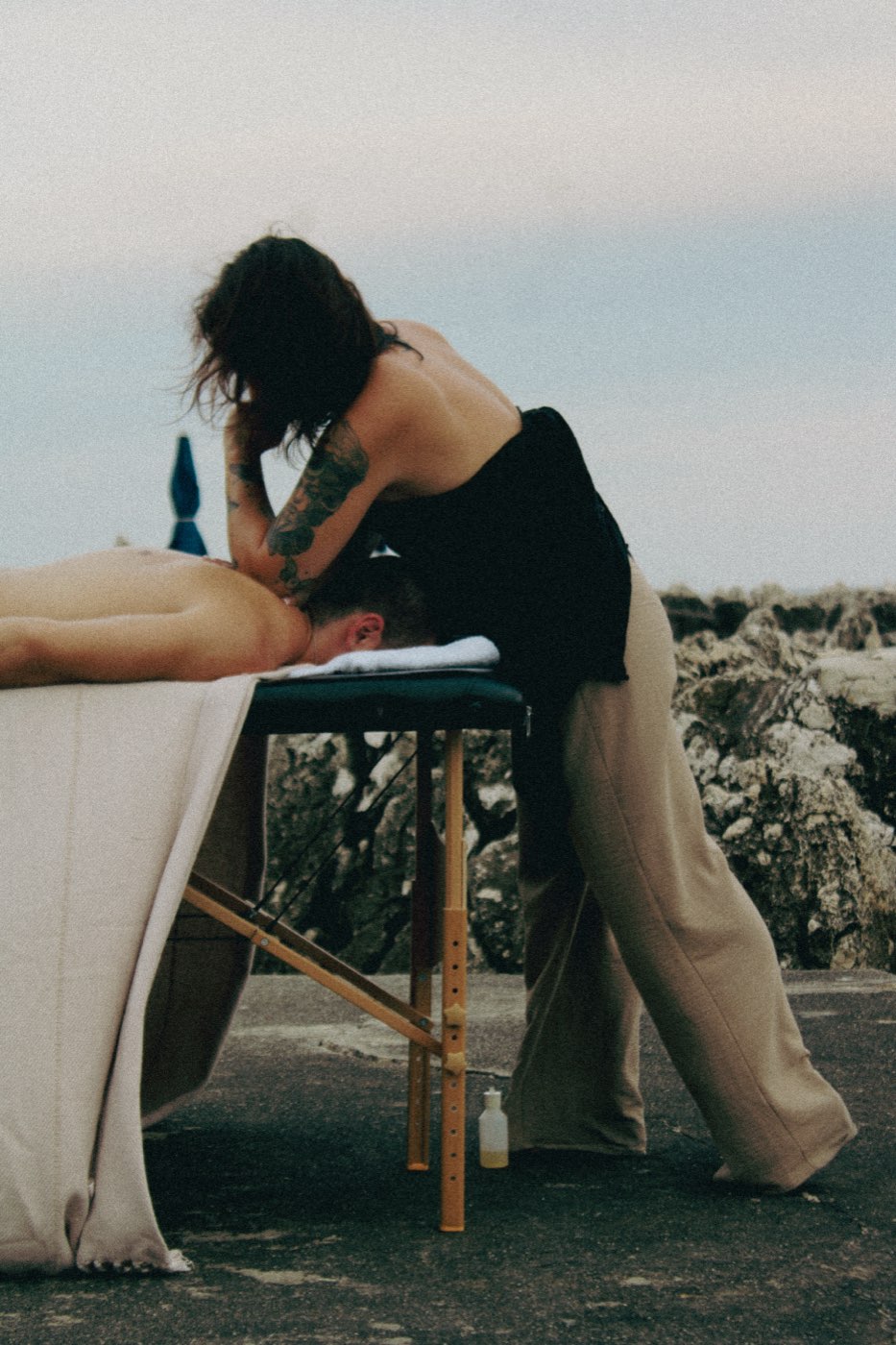 Julie working on a client, massage table facing the sea on the French Riviera